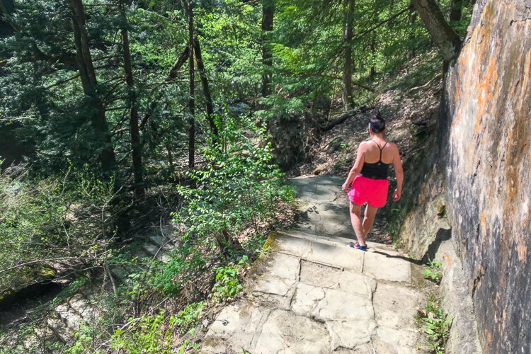 Navigating a stone stairway on Henry Church Rock Loop trail.